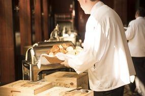 the waiter makes bread on a tray