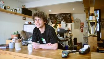 Happy waiter in cafe