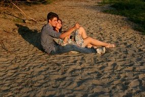 couple in love sitting on the sand