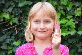 Smiling Girl with pink lollipop