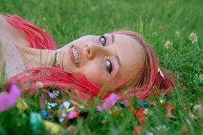 girl with pink hair lying on the