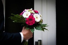 bouquet in the hands of the groom