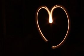 light painted heart form at black background