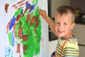 boy painting with brush