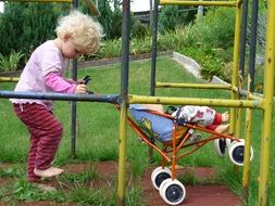 little girl playing with a pram