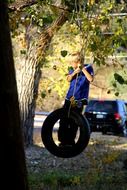 boy on the tire swing