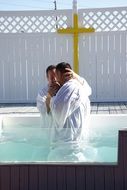 Adult man in pool baptism