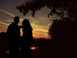 lovers on a background of sunset in the dark