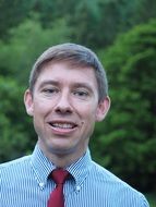 smilimg man in stylish shirt and red tie