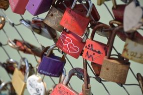 Colorful locks on metal fence