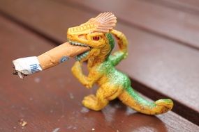 cigarette but in mouth of dragon figure