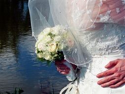 wedding bouquet in the hands of the groom