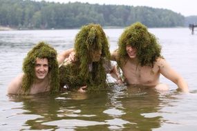three young men in algae in water