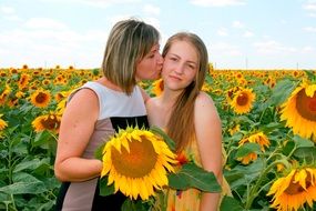 mother and daughter on the sunflower field