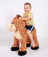 smiling boy on a big soft toy
