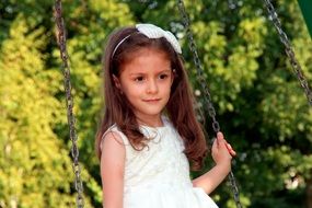 swinging girl in white dress