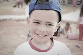 smiling boy in a blue cap