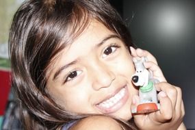 happy girl with a ceramic statuette