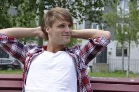 Attractive young man on park bench