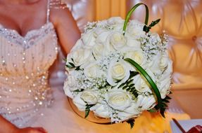 bouquet of white roses in the hands of the bride