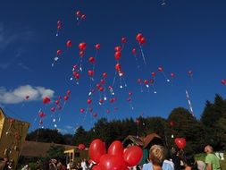 A lot of red balloons at the celebration