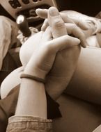 people hold hands in the car