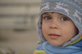 The child's face in a hat and scarf