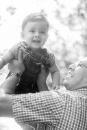 happy child in dad's arms