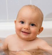 happy baby in water close up