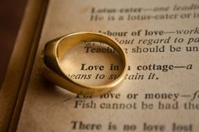 gold ring on an open book