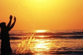 happy boy splashing water