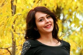 girl on a background of yellow leaves