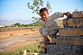 boy on a stone wall