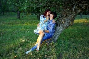 Romantic couple sitting on a tree