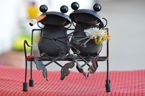 Funny metal frogs on bench