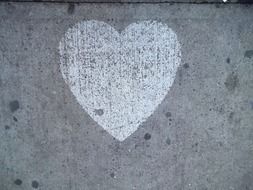 White heart drawing on a sidewalk