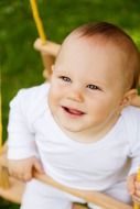 photo of kid on a swing