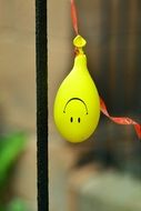 smiley on yellow balloon upside down