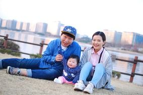 korean family sitting by the river