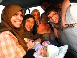 big happy family in the salon of a car