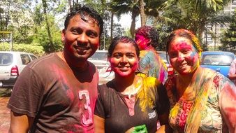 people in colorful paint at indian holi festival