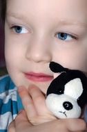 child holding a toy dog