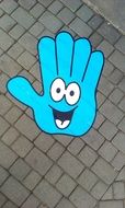 Blue hand with smile on the ground