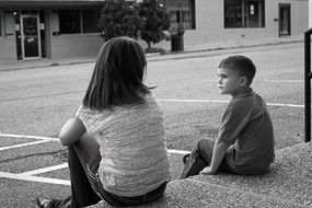 brother and sister on a city street