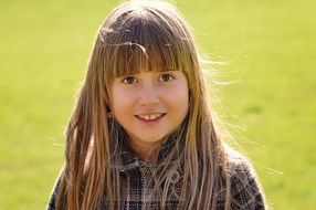 portrait of a girl on a background of green grass