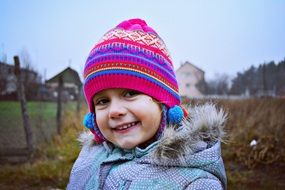 girl in a pink hat and autumn jacket