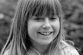 black and white portrait of a laughing girl
