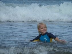 Playing little boy in ocean