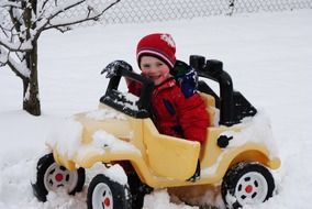 boy on a typewriter drives through the snow