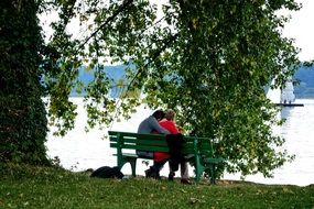 couple in love on benches by the river